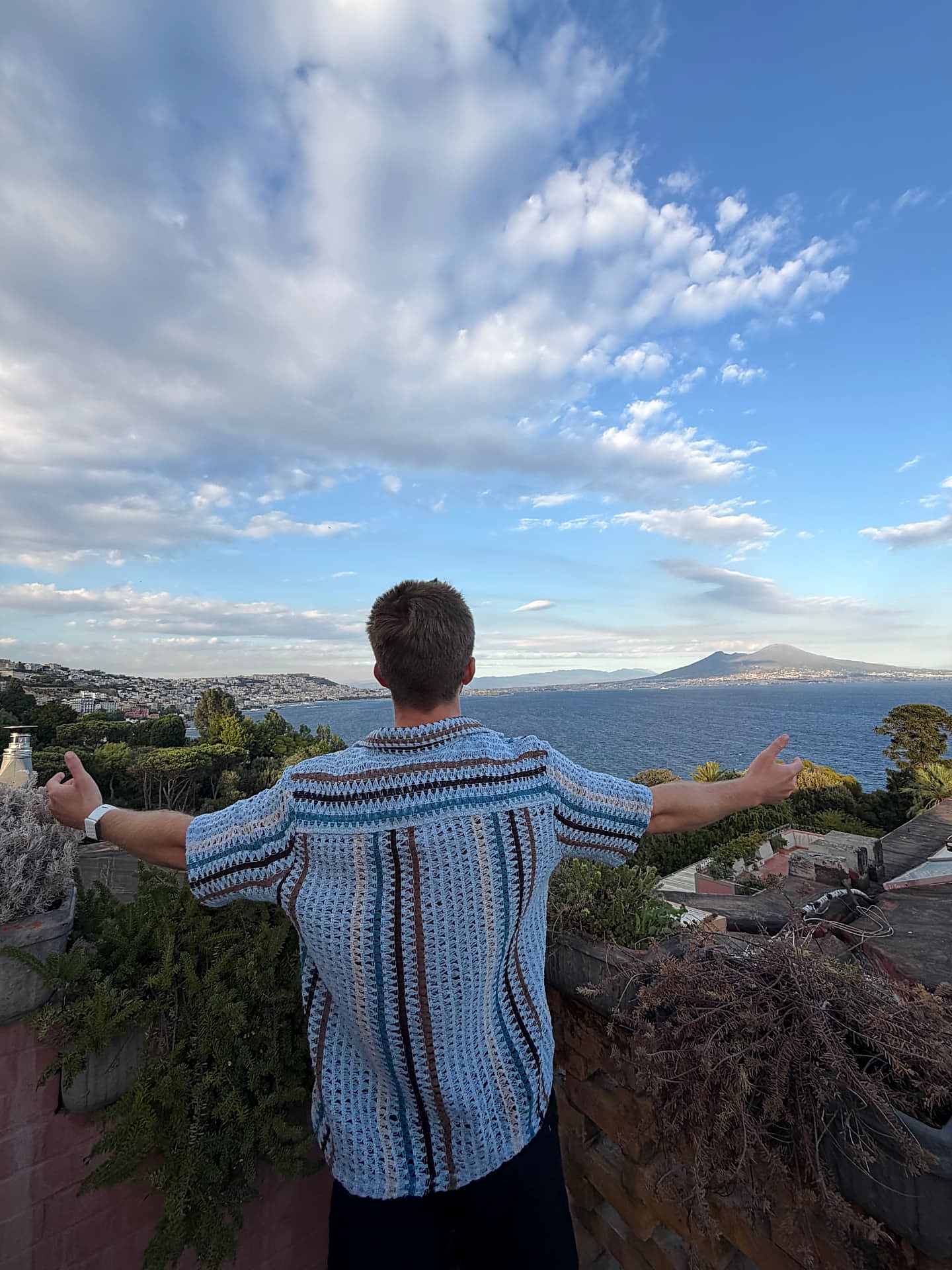 Mark Moholt overlooking the coast with his arms open